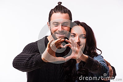 Portrait of smiling beauty girl and her handsome boyfriend making shape of heart by their hands. Stock Photo