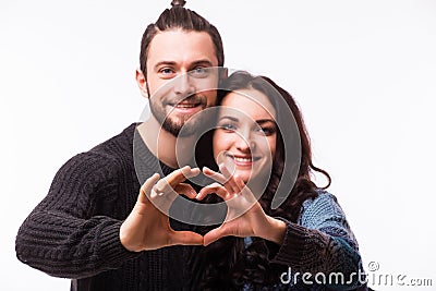 Portrait of smiling beauty girl and her handsome boyfriend making shape of heart by their hands. Stock Photo