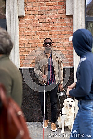 Portrait of smiling black blind man with dog Editorial Stock Photo