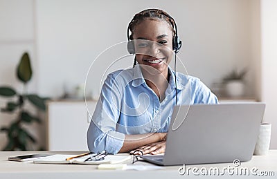 Portrait Of Smiling Black Woman Call Center Operator At Workplace In Office Stock Photo
