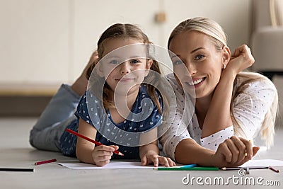 Portrait of smiling bonding family drawing together at home. Stock Photo