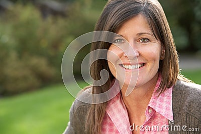 Portrait Of Smiling Brunette Woman Outdoors Stock Photo