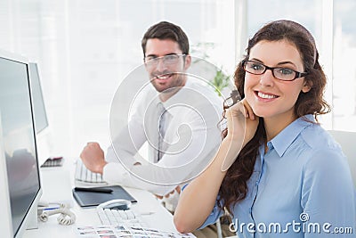 Portrait of smiling business coworkers sitting Stock Photo