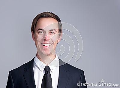 Portrait of a smiling business man in suit isolated on gray background Stock Photo