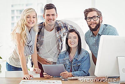 Portrait of smiling business professionals using digital tablet Stock Photo