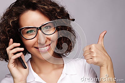 Portrait of smiling business woman phone talking and show OK Stock Photo