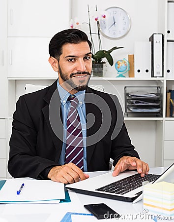 Portrait of smiling businessman who is productive working Stock Photo
