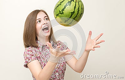 Portrait of smiling caucasian woman girl catching or throwing green watermelon. Healthy lifestyle, fruit vegetarian diet. Stock Photo