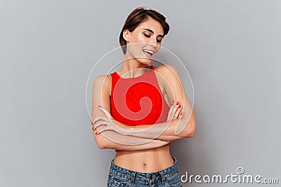 Portrait of a smiling cheerful brunette girl with hands crossed Stock Photo