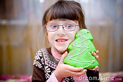 Portrait of smiling child girl with gingerbread Stock Photo