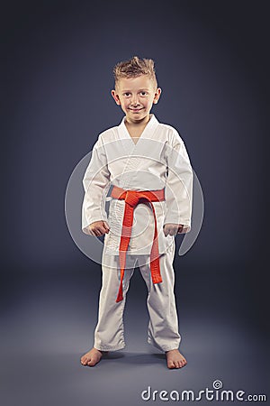 Portrait of a smiling child with kimono practicing martial arts Stock Photo