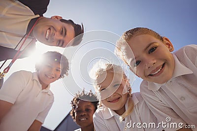 Portrait of smiling coach and schoolkids Stock Photo