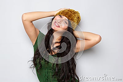 Smiling cool woman with unique yellow hat Stock Photo