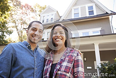 Portrait Of Smiling Couple Standing In Front Of Their Home Stock Photo