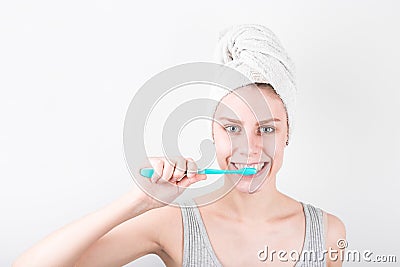 Portrait of a smiling cute woman holding toothbrush snd cleaning tooth isolated on a white background Stock Photo