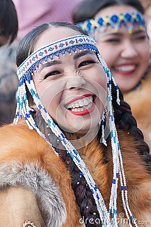 Portrait of smiling expression female in national clothing indigenous inhabitants of Kamchatka. Celebration Koryak Editorial Stock Photo