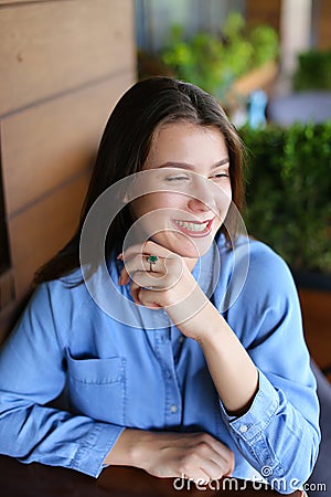 Portrait of smiling girl with everyday makeup and wearing jeans shirt. Stock Photo