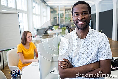 Portrait of smiling graphic designer standing with arms crossed Stock Photo