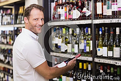 Portrait of a smiling handsome having a wine bottle in her hands Stock Photo