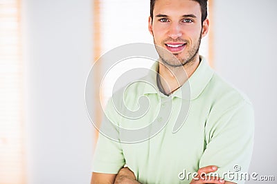 Portrait of smiling handsome masseur with arms crossed Stock Photo