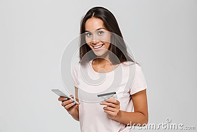 Portrait of a smiling happy asian woman holding credit card Stock Photo