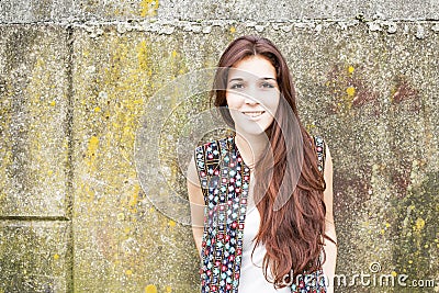 Portrait of smiling hippie woman on urban background. Stock Photo