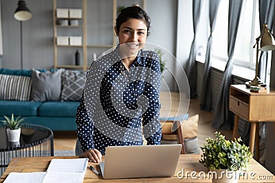 Portrait of smiling Indian girl posing at home workplace Stock Photo