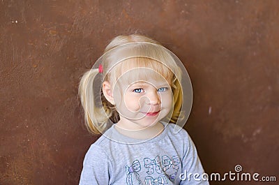 Portrait of smiling little funny blonde girl Stock Photo