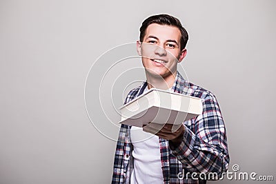 Portrait of a smiling man giving book Stock Photo