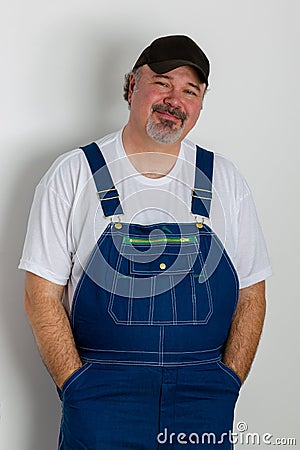 Portrait of smiling man wearing dungarees Stock Photo