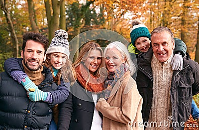 Portrait Of Smiling Multi-Generation Family Walking Along Autumn Woodland Path Stock Photo