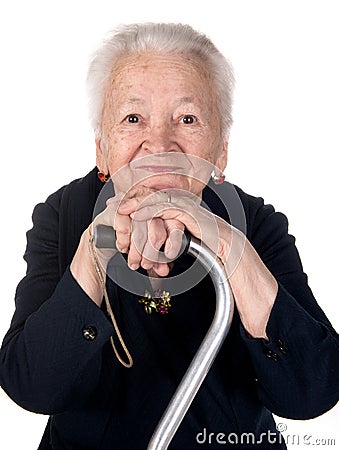 Portrait of smiling old woman sitting with a cane Stock Photo