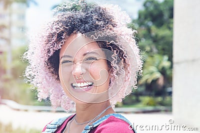 Portrait of a smiling punk girl with pink hair Stock Photo