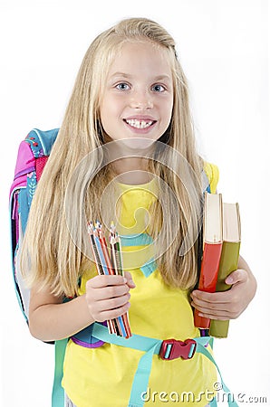 Portrait of smiling school girl child with backpack, holding crayons and books. Education concept Stock Photo