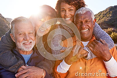 Portrait Of Smiling Senior Friends Having Fun Walking In Countryside Together Stock Photo