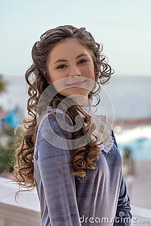 Portrait of a smiling sly naughty girl with curlers in an old retro dress Stock Photo