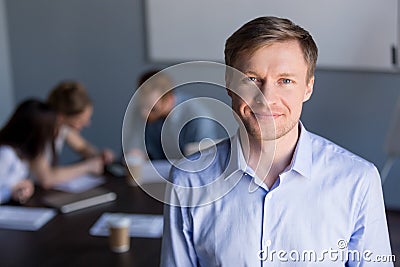 Portrait of smiling successful company ceo with team at backgrou Stock Photo