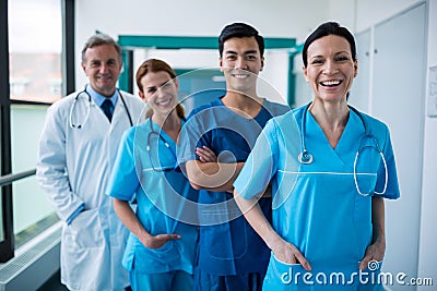 Portrait of smiling surgeons and doctors standing in corridor Stock Photo