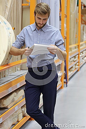 Portrait of a smiling warehouse keeper at work Stock Photo