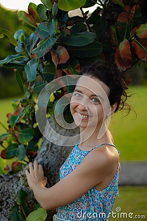 Portrait of smiling woman. Close up. Focus on the face. Tree background Stock Photo