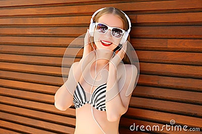 Portrait smiling woman listens to music in headphones Stock Photo