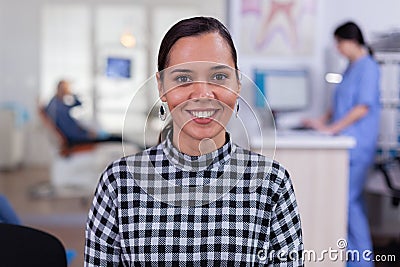 Portrait of smiling woman patient looking on camera sitting on chair Stock Photo