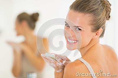 Portrait of smiling woman washing hands with soap Stock Photo