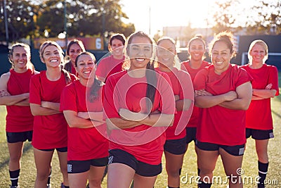 Portrait Of Smiling Womens Football Team Training For Soccer Match On Outdoor Astro Turf Pitch Stock Photo