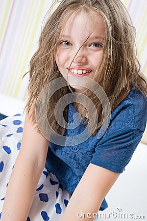 Portrait of a smiling 8 year old girl in a hat Stock Photo