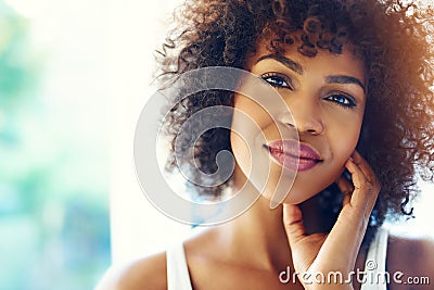 Portrait of smiling young black woman in sunshine Stock Photo