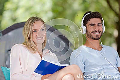 Portrait smiling young couple in tent Stock Photo
