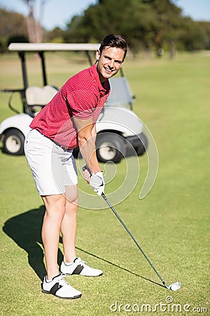 Portrait of smiling young man playing golf Stock Photo