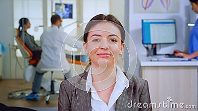 Portrait of smiling young patient looking on webcam sitting on chair Stock Photo