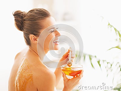 Portrait of smiling young woman holding plate with honey Stock Photo